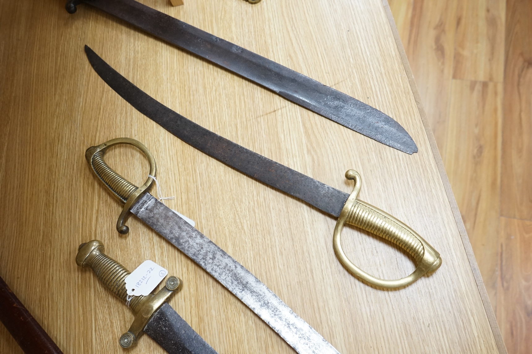 A mid 19th century infantryman’s short sword Gladius with cast brass hilt of universal pattern, stamped 306, together with two Continental infantyman’s side arm briquet, one stamped; M. and R. Boker Remscheid (3)